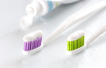 Fototapeta na wymiar sqweezed toothpaste and two toothbrush on white background