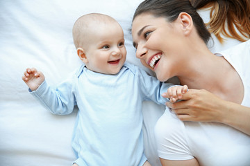 Mother and baby on bed