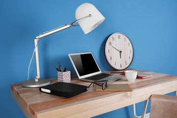 Working place on blue wall background