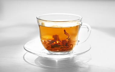 Glass cup of tea on table