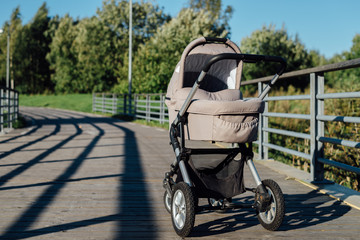 Fototapeta na wymiar Baby stroller on running path in park