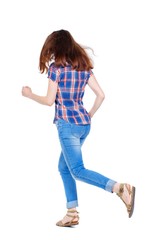 back view of running woman. beautiful girl in motion. Girl in plaid shirt with fluttering hair runs off into the distance.