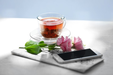 Cup of tea with flowers on table