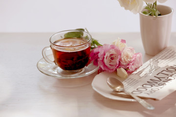 Cup of tea with flowers on table