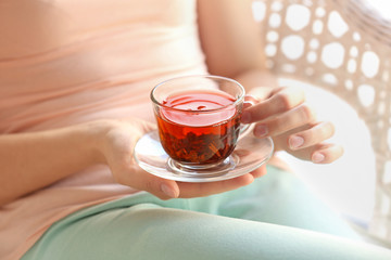 Woman holding cup of tea