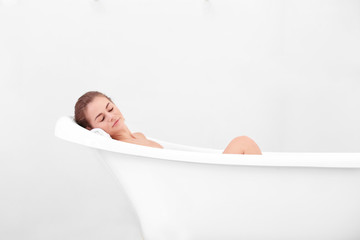 Beautiful girl relaxing in bathtub