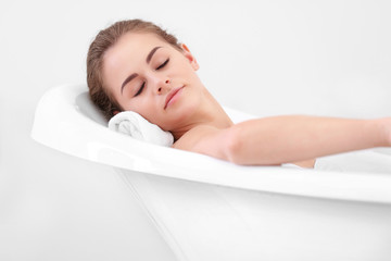 Obraz premium Beautiful girl relaxing in bathtub