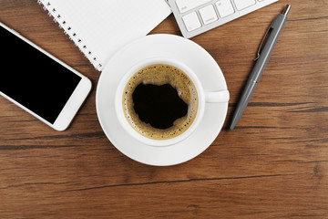 Fototapeta na wymiar Cup of coffee on modern workplace