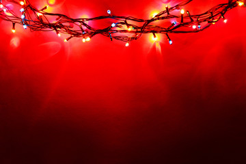 Christmas lights on color background