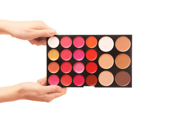 Female hands holding eye shadow palette, isolated on white