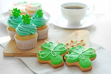 Tasty cupcakes and cookies on table. Saint Patrics Day concept