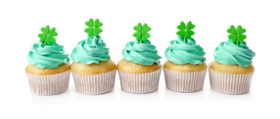 Tasty cupcakes with clover, isolated on white. Saint Patrics Day concept