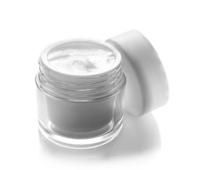 Glass bowl of facial cream isolated on white