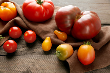 Composition of red and yellow tomatoes on dark wooden background