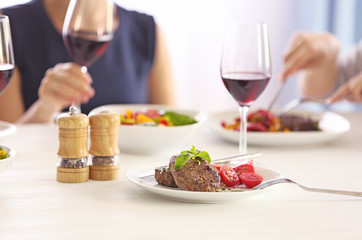 Tasty steak with fresh tomatoes on table