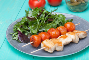 barbeque chicken with tomatoes in a plate with salad