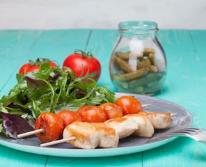 barbeque chicken with tomatoes in a plate with salad