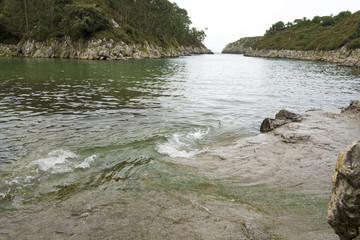 Guadamia beach at high tide in Asturias, Spain.