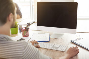 Rear view of man and his computer.