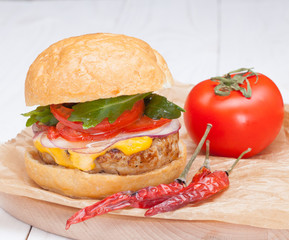 hamburger cheese onions sauce tomatoes on paper