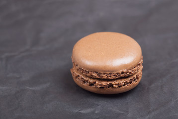 Beautiful delicious cakes with cream macaroon chocolate pistachio nuts vanilla strawberry cherry on dark background