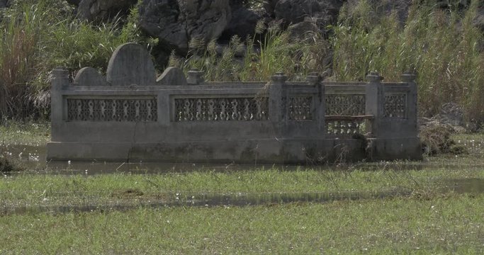 Cemetery with stone border in the water. Hanoi, Vietnam