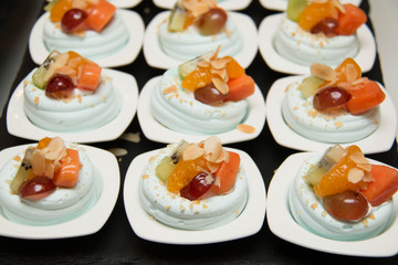  merangue topped with mixed fruit