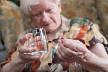 Old woman taking medication