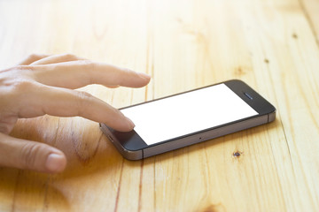 woman using smartphone with blank screen on table background