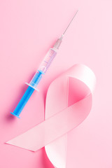 Pink ribbon and syringe.