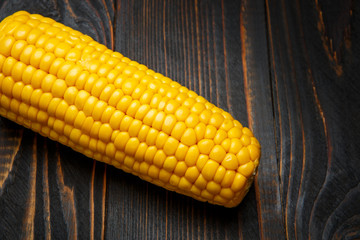 An ear of corn on a wooden background