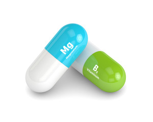 3d rendering of magnesium nad vitaminum B6 pill over white backg - obrazy, fototapety, plakaty