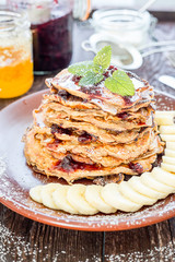 Stack of Pancakes with Banana and Caramel for a Breakfast