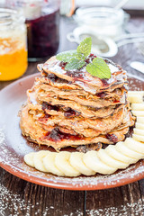 Stack of Pancakes with Blueberry Jam, Banana and Maple Syrup