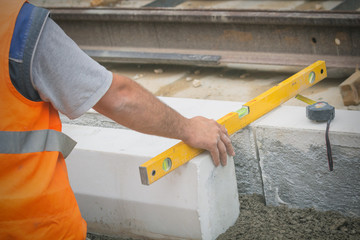 Construction workers leveling concrete pavement.