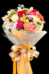 bouquet of various colorful flowers with ribbon on black