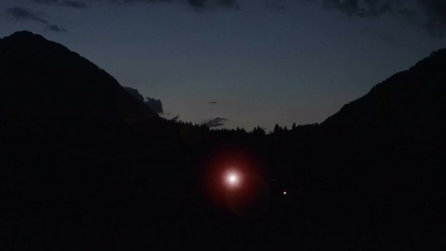 cgi compositing showing two bright glowing lights dancing in the night sky near a mountaintop