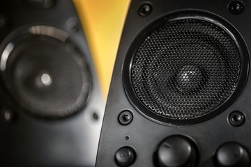 Audio speakers on yellow background