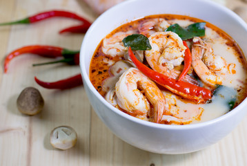 Tom yum kung, and condiment, on wooden table, style blur,  Selec