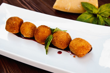 Cheese croquettes (Cheese breaded Camembert with berry sauce)