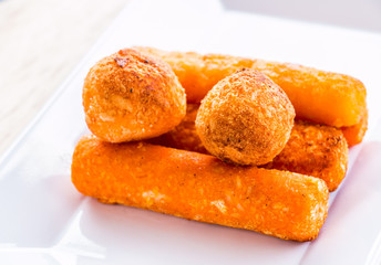 cheese stick and ball on plate
