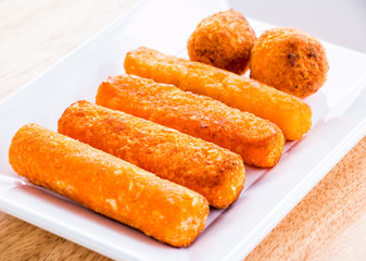 cheese stick and ball on plate