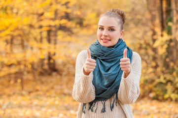 Beautiful female walking outdoors in autumn