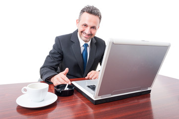 Young executive manager drinking coffee and smoking