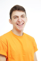 Close-up portrait of smiling guy . Over white background. Smiling guy in an orange T-shirt. Age defying skin care anti aging flawless spa treatment beautiful man smiles