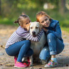 Two little girls with a dog.