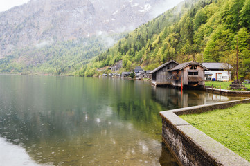 Fototapeta na wymiar Cottages in the lake in Hallstatt a foggy and rainy day