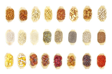 Super food selection in wooden bowls on white background, view from above.