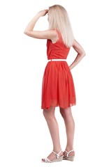 back view of standing young beautiful  blonde woman. she shyly looks at something. girl  watching. Rear view people collection.  backside view of person.  Isolated over white background.