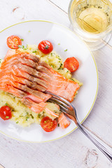 Salmon, Tomato and Smashed Potato with  Spring Onion and Coriander. View from above, top studio shot